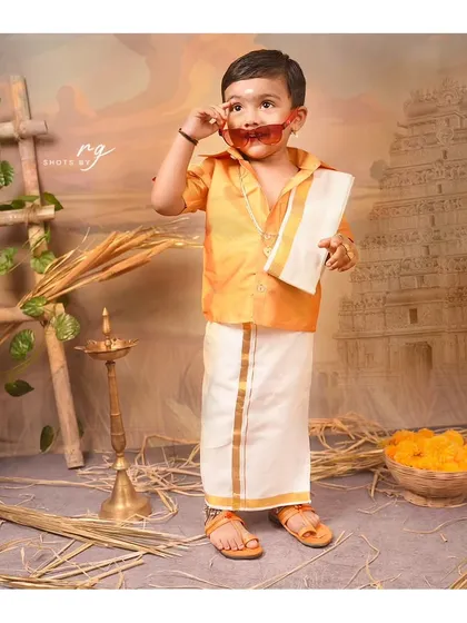 A playful pose with some cool shades. We encourage kids to have fun and be themselves during our photoshoots.