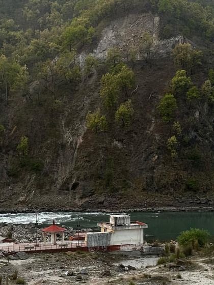 A view of the Phool Chatti Ashram nestled by the river. It's a place of deep peace, perfect for a spiritual getaway and yoga immersion.