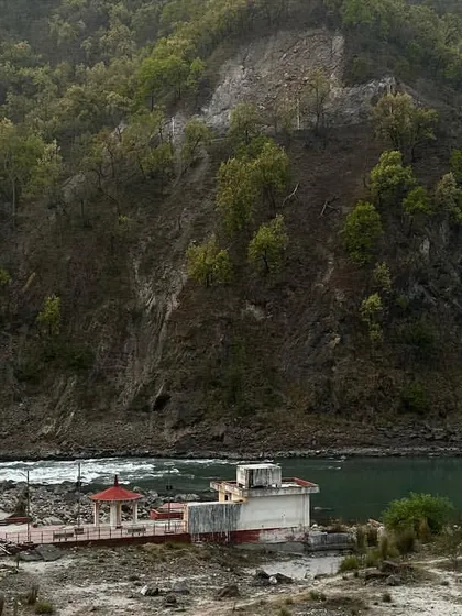 A view of the Phool Chatti Ashram nestled by the river. It's a place of deep peace, perfect for a spiritual getaway and yoga immersion.