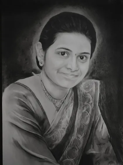 A beautiful charcoal portrait of a woman in a saree, with a soft halo of light around her. This reverse drawing technique creates a stunning effect.