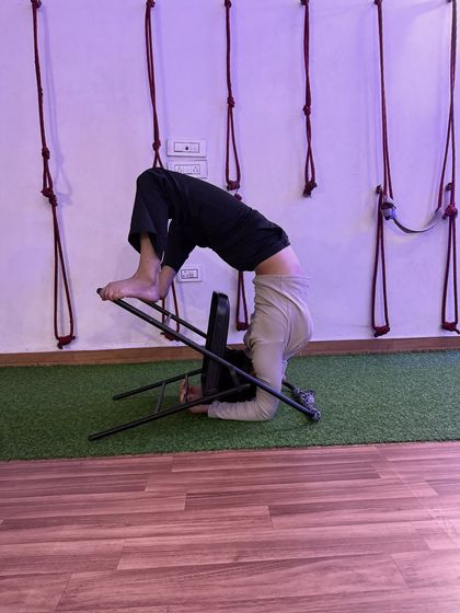 This variation of a headstand with a chair helps in building the core strength needed for unsupported inversions.