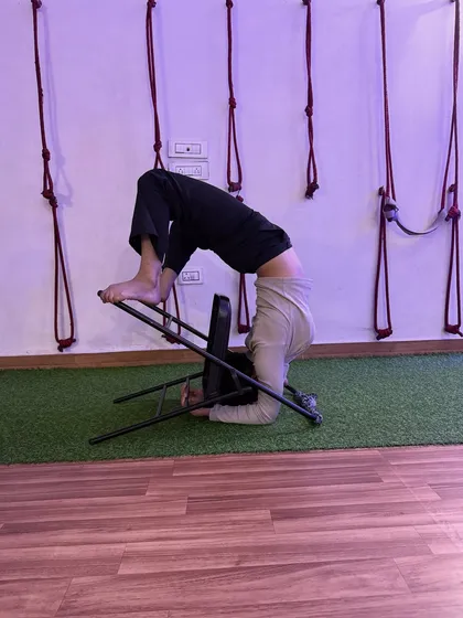 This variation of a headstand with a chair helps in building the core strength needed for unsupported inversions.
