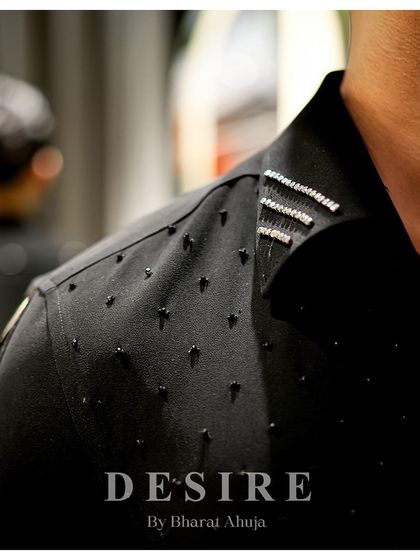 A macro view of the intricate beadwork and crystal detailing on the collar and shoulder of one of my custom black shirts. This is luxury you can see and feel.