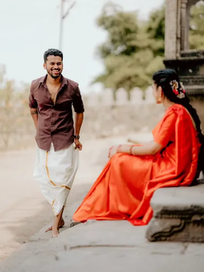 A candid, happy moment captured during a pre-wedding shoot. The groom's spontaneous smile is what makes this photograph a genuine memory.