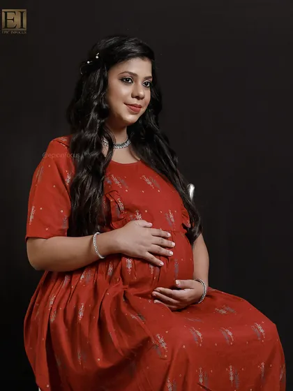 A comfortable yet stylish printed red dress, perfect for a relaxed and happy studio portrait.