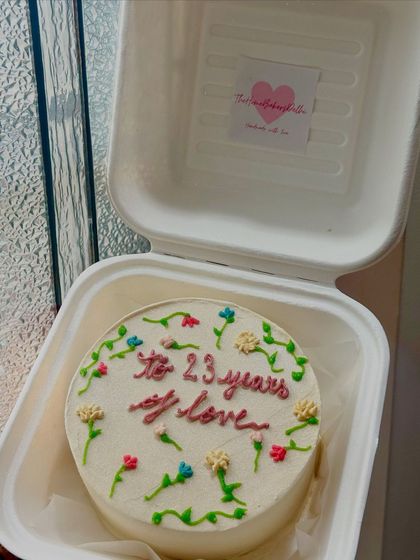 A floral bento cake celebrating 23 years of love. The tiny, hand-piped flowers add a delicate and personal touch to this anniversary cake.
