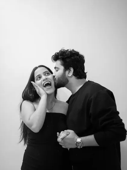 Pure, spontaneous joy. I prompted Omkar to give Riya a surprise kiss, and her reaction is priceless. Capturing these candid, happy moments in a simple black and white format makes the emotion even more powerful.