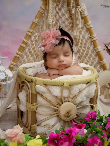 Surrounded by beautiful flowers, this baby girl is resting peacefully. I have a wide variety of props, baskets, and floral arrangements in my studio to customize your session.