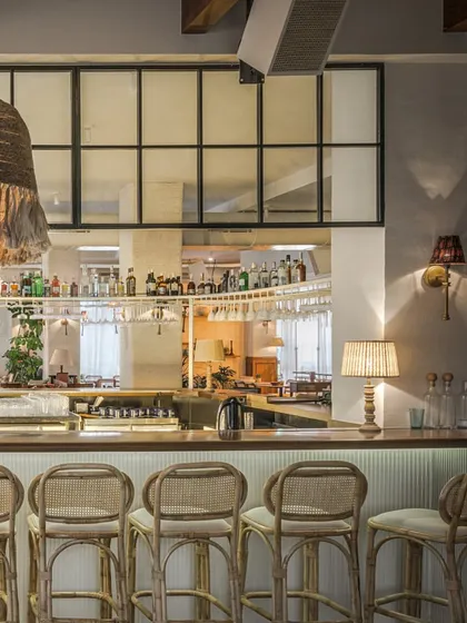 For the EVE restaurant in Powai, we crafted an atmosphere of nostalgic comfort and vintage charm. This view of the bar highlights our use of natural textures like rattan and woven light fixtures to create a warm, inviting social hub. The design encourages connection, making it a space people want to return to.