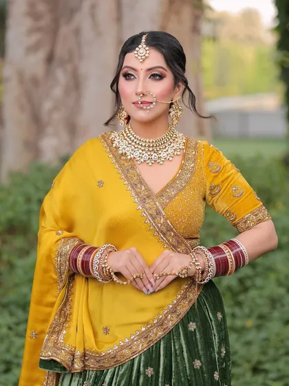 A regal pose from our beautiful bride. The makeup focuses on sharp, defined eyes and a flawless complexion, allowing her traditional jewelry and outfit to take center stage.