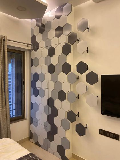 A detailed shot of the 3D hexagonal wall panel. This feature wall also cleverly conceals a space-saving foldable bar unit, as seen in our featured video.
