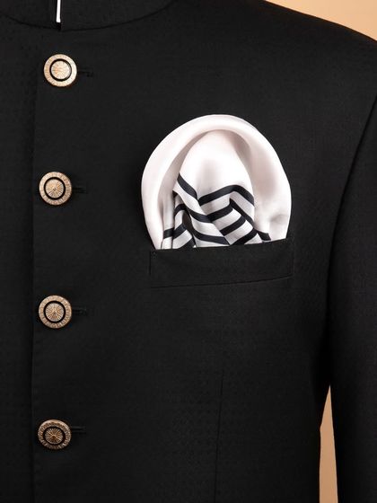 A black and white striped pocket square folded neatly in a jacket, showcasing a modern, minimalist look.