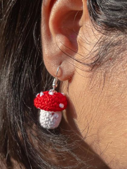 A close-up on the ear, showing how the mushroom earrings sit. They are small enough for everyday wear but quirky enough to get noticed.