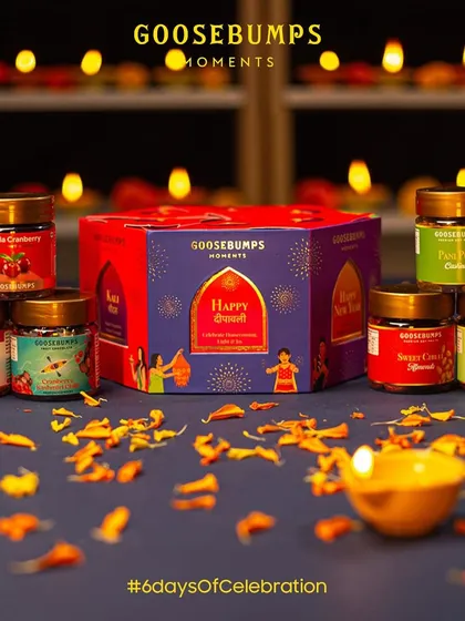 Here is my '6 Days of Celebration' Diwali hamper, laid out with all its treasures. The lantern-shaped box contains six different jars, including Pani Puri Cashews and Shahi Paan Raisins, each one celebrating a day of the festival.