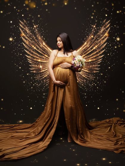 A golden glow of motherhood, wings of hope, and the beauty of life captured in its purest form. This angelic masterpiece is ethereal yet powerful.