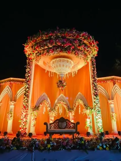 The full view of the grand palace stage at night, fully lit and ready for a royal wedding celebration.