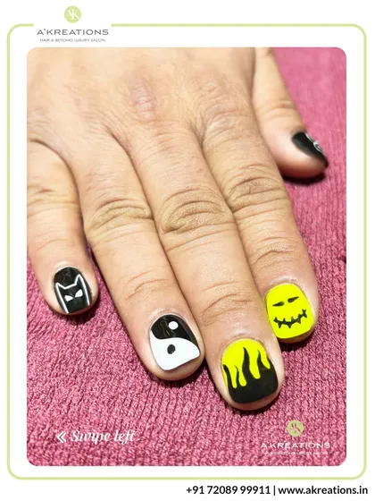 This view highlights the spooky-themed nails, including the Batman logo, a ghost face, and flame art, perfect for Halloween or a bold statement.