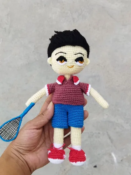 This custom doll was made for a badminton enthusiast. I included details like his sportswear, hairstyle, and even a tiny crochet badminton racket.