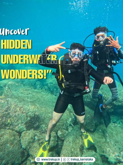 Two divers posing underwater, inviting you to uncover the hidden wonders of the sea with our scuba diving trips.