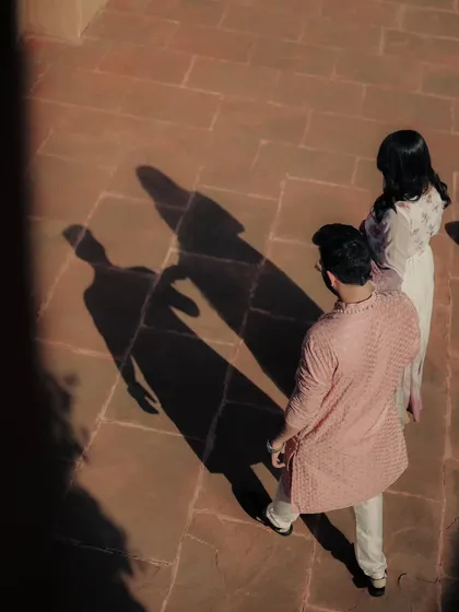 An artistic shot focusing on the couple's shadows. I love experimenting with light and shadow to create dramatic and unconventional images.