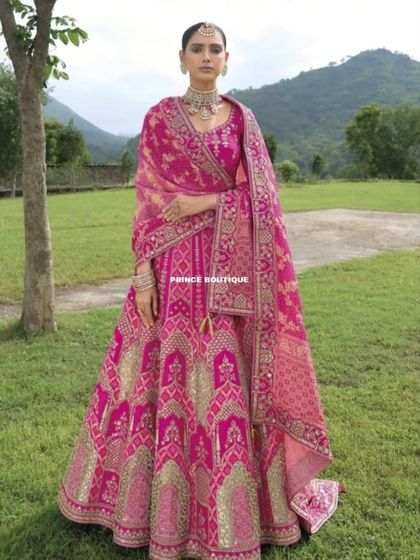 A full view of the pink bridal lehenga, showcasing its beautiful flare and the grand, flowing dupatta. This is a perfect choice for a bride who loves traditional handwork.