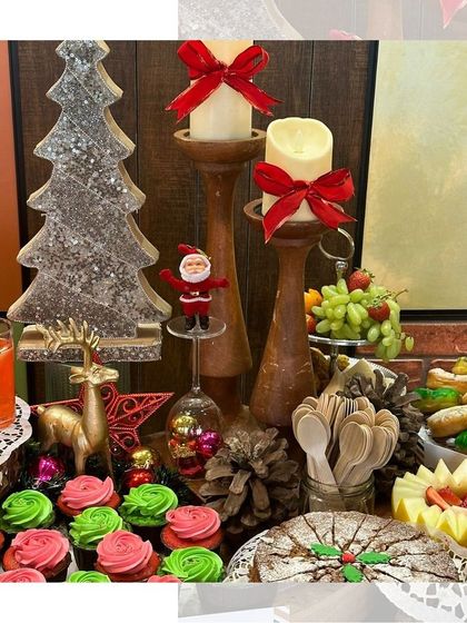 A close-up of our Christmas-themed grazing table with red and green cupcakes, a festive fruitcake, and other holiday treats.