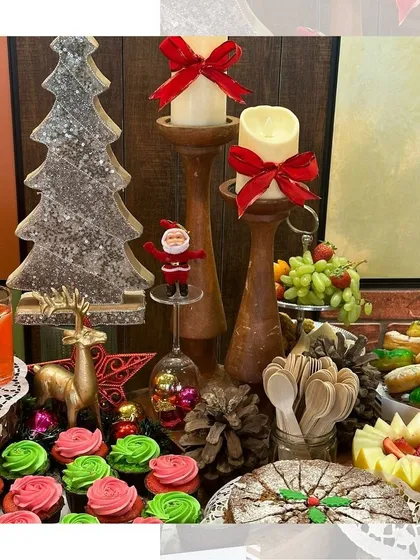 More details from our Christmas celebration catering. We use festive decor like glittery trees, candles with red bows, and a classic fruitcake to create a warm and inviting holiday atmosphere.