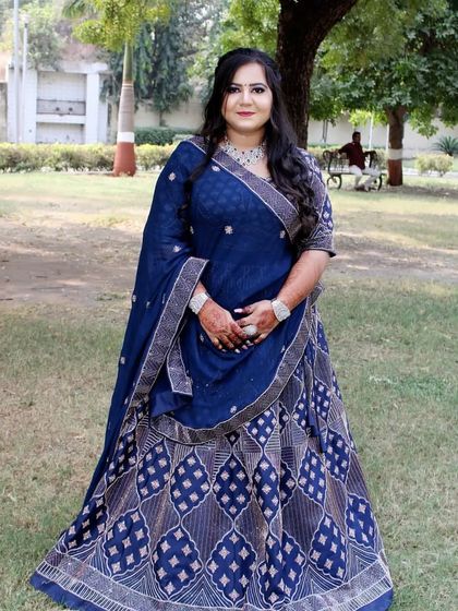 The complete look, from the detailed lehenga to the elegant makeup and hair. Perfect for a daytime engagement ceremony.