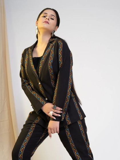 A three-quarter shot that highlights the sharp tailoring of the blazer and the model's strong pose. This is a perfect example of a clean, professional, and stylish corporate headshot.