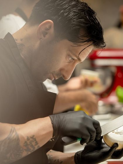 Chef Andres Lara demonstrates his meticulous technique for finishing a modern pastry.