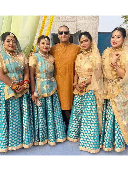 Our team of talented folk dancers posing with a happy client after a successful event. We are proud to bring traditional Indian culture to celebrations.