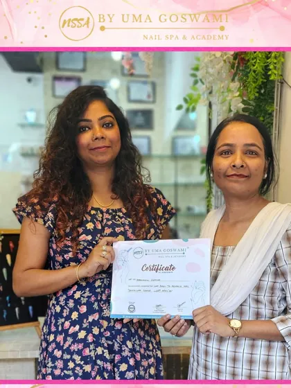 Rukmini celebrating her graduation. She is now a confident, certified nail artist ready to start her career.