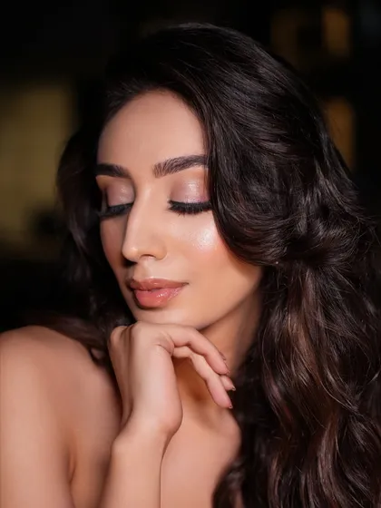A close-up showing the soft, minimal glam for a cocktail look. The focus is on flawless skin and subtly enhanced features, creating an elegant and sophisticated vibe.