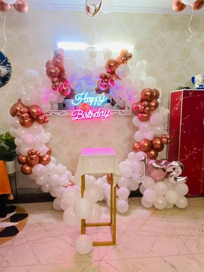 The rose gold and white balloon ring setup, showing the full arrangement with the cake pedestal. This is a popular choice for elegant and Insta-worthy parties.