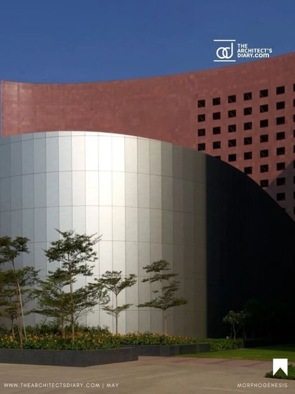 A stunning shot from our feature in The Architect's Diary, showcasing the interplay of form and material at the Surat Diamond Bourse, with its curved silver volume set against the red granite facade.