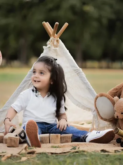 Our outdoor sessions are perfect for a relaxed, natural vibe. We set up this charming boho-themed teepee in a park, using natural light to capture this little one's curious and playful spirit.