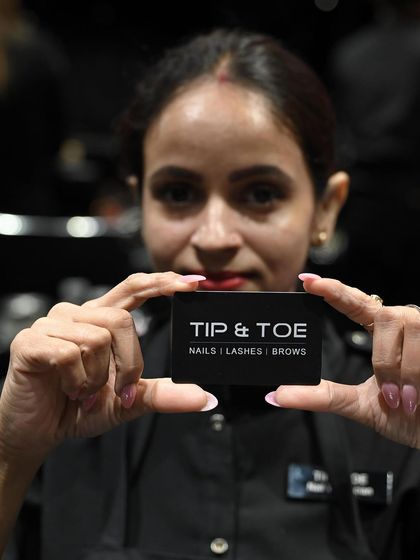 A portrait of one of our skilled technicians, ready to create your next beautiful nail look.