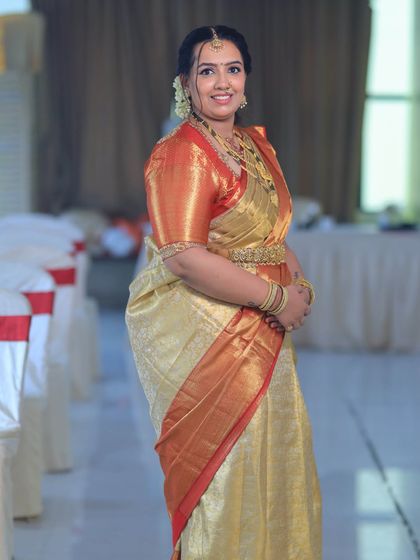 A full-length view of Chandana's classic South Indian look. The Kanjeevaram saree is draped perfectly to showcase its beauty, complemented by her glowing makeup.