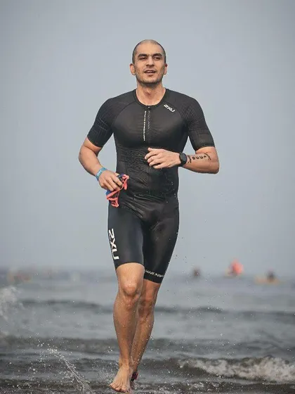 Emerging from the water after the swim portion of the Ironman 70.3. Our coaching covers all three disciplines of the triathlon.