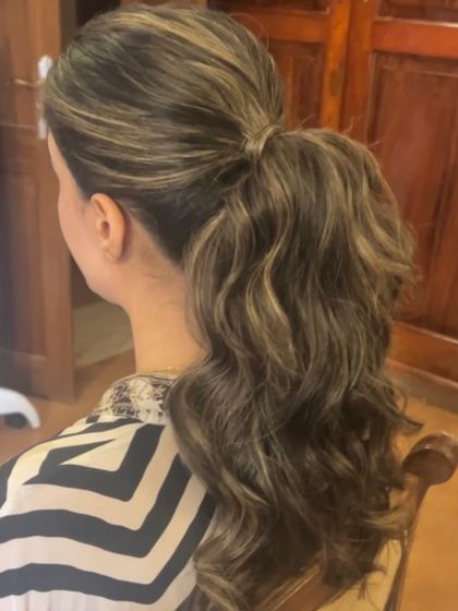 A behind the scenes look at creating a wavy ponytail on highlighted hair. The different tones in the hair add beautiful dimension to the style.
