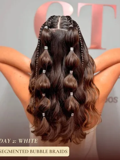 On day two, for the color white, I suggest these segmented bubble braids. This playful style is modern and fun, with small braids accenting the larger bubbles for extra texture.
