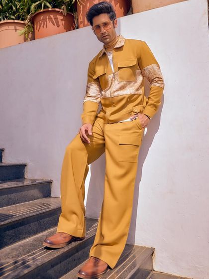 A suit that multitasks. This mustard-colored co-ord set from the Sukoon collection transitions from daytime elegance to evening drama, perfect for both parties and shaadis.
