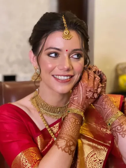A happy, candid shot of the bride, her hair and makeup looking flawless.