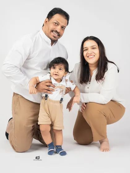 A sweet family photo with a curious toddler. Capturing these early years is so important, and this portrait shows the love surrounding this little one as he begins to stand on his own.