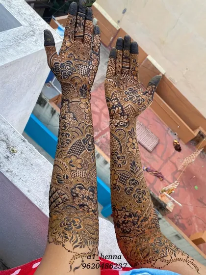 This full bridal henna application, extending up the arms, was created with my signature organic cones. The design is still in its paste form, showing the neatness of application before the color develops.
