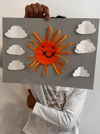 Another creative take on the sun craft, this one with a big smile and a sky full of clouds.
