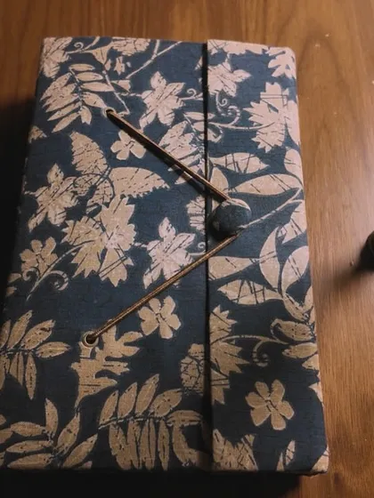 A still life from the 'Svarakshara' music video, featuring a journal and a quill pen. This visual represents the lyric-writing process, which is the foundation of any great song.