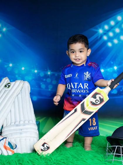 Our future Virat Kohli is ready to hit a six, posing confidently with his cricket bat.