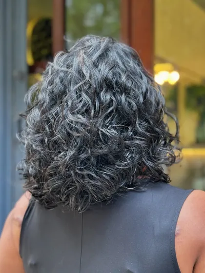 A classy curly bob is always a good idea. This timeless haircut is perfect for adding shape and volume, creating a chic and easy-to-manage style for wavy and curly hair.