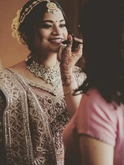 A candid moment of putting the final touches on the bride's makeup. I ensure every detail is perfect before she walks down the aisle.